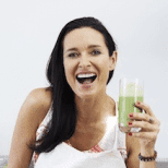 Image of Amanda Brocket laughing while holding a green juice