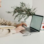 Small business owner checking SEO and speed reports on laptop