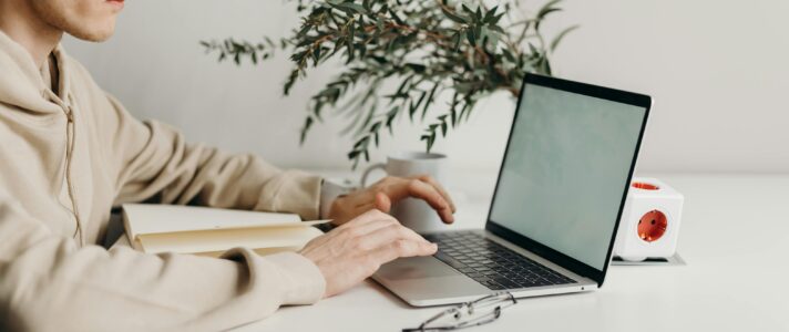Small business owner checking SEO and speed reports on laptop