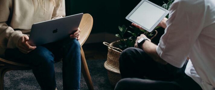 Business owner reviewing best website design elements with a web designer