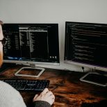 Small business owner reviewing hiring checklist with professional website designer