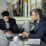 Marketing manager reviewing website analytics with website developers team