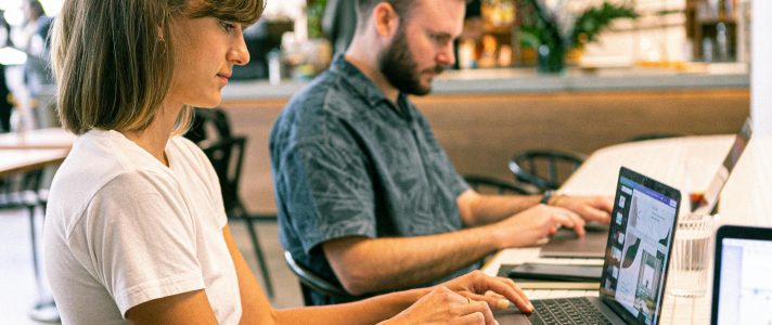 Web design team reviewing homepage conversion elements on laptop